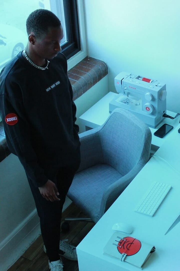picture of Cheikhou standing looking at computer for Xobei